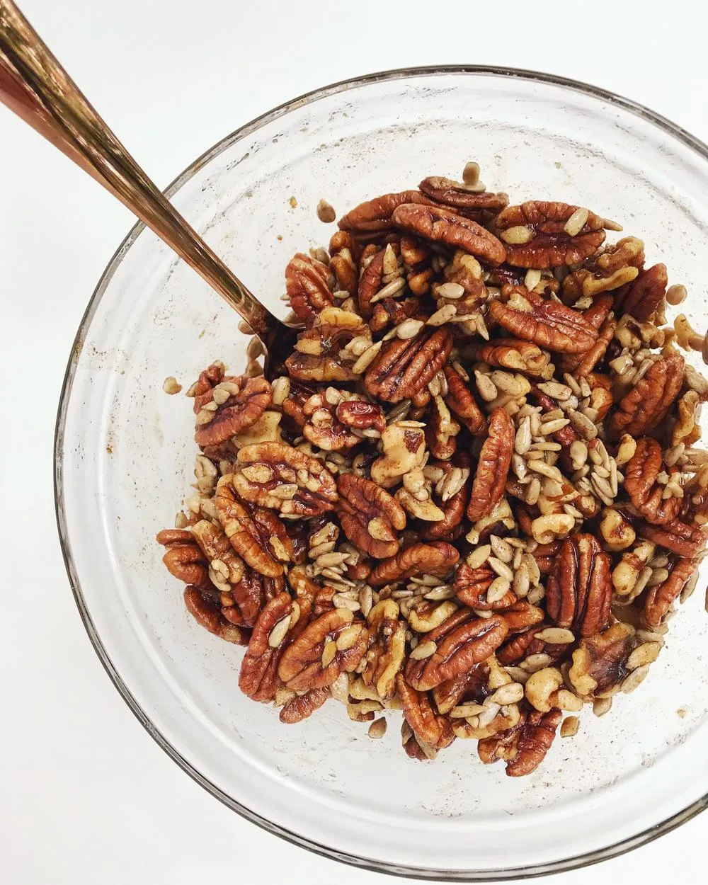 Mixing bowl full of pecans, walnuts, and sunflower seeds.
