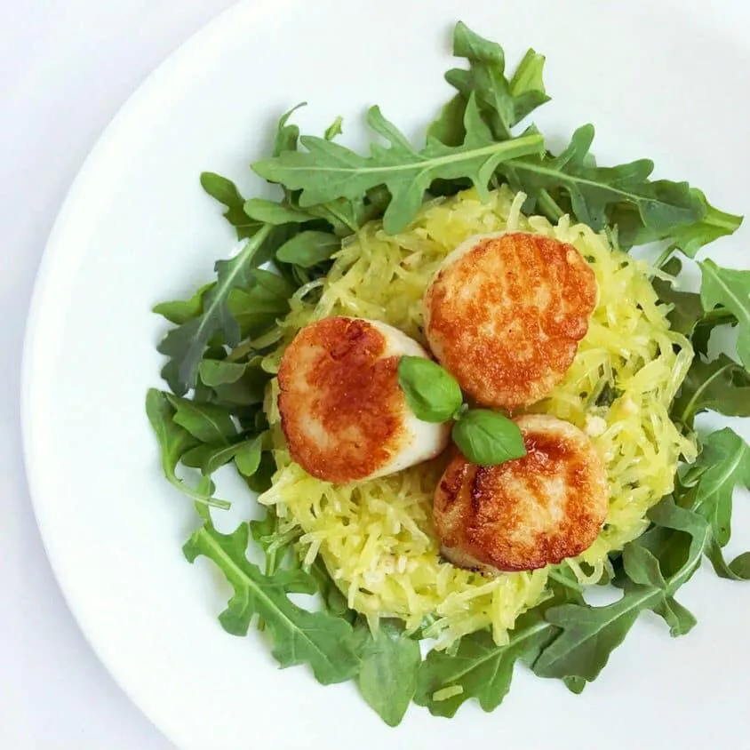 Seared scallops with spaghetti squash and fresh arugala.