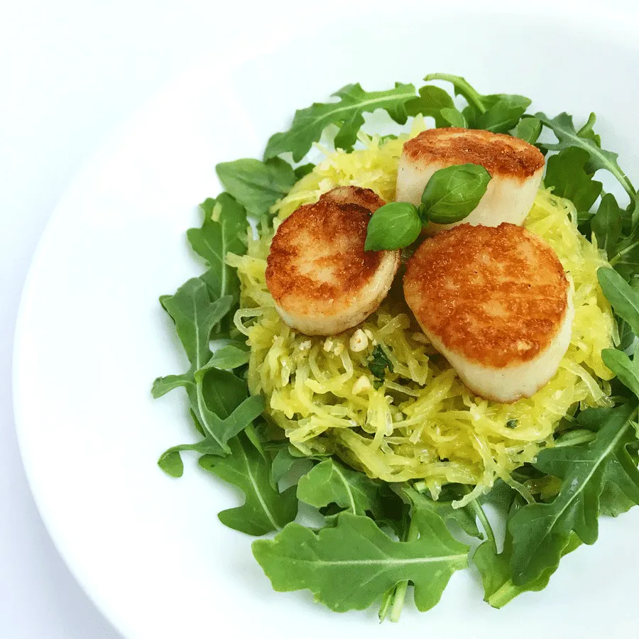 Seared scallops with spaghetti squash and fresh arugala.