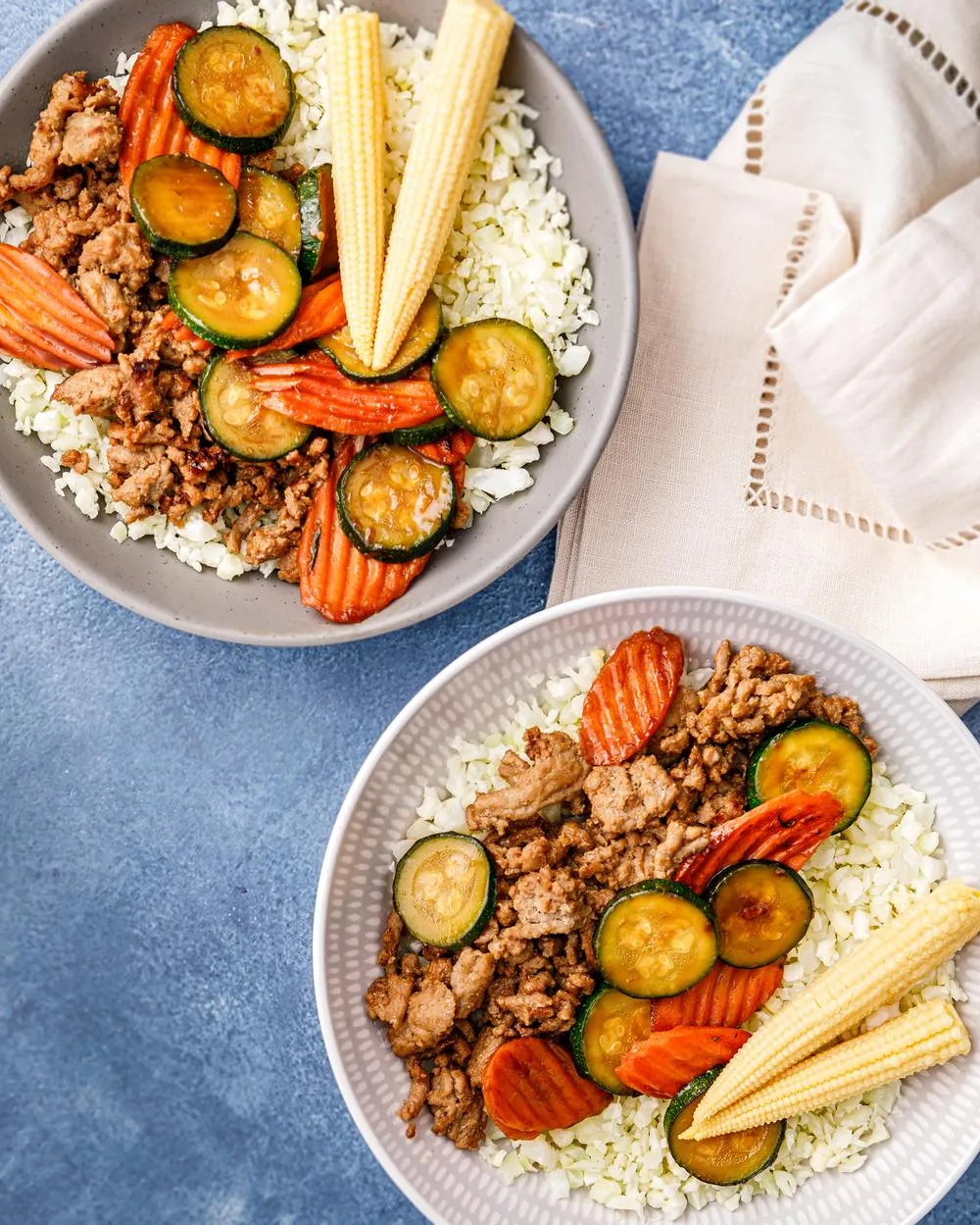two bowls of teriyaki turkey and vagetables