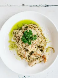 a white plate of easy, healthy, acid reflux-friendly peso chicken pasta on a whtie table