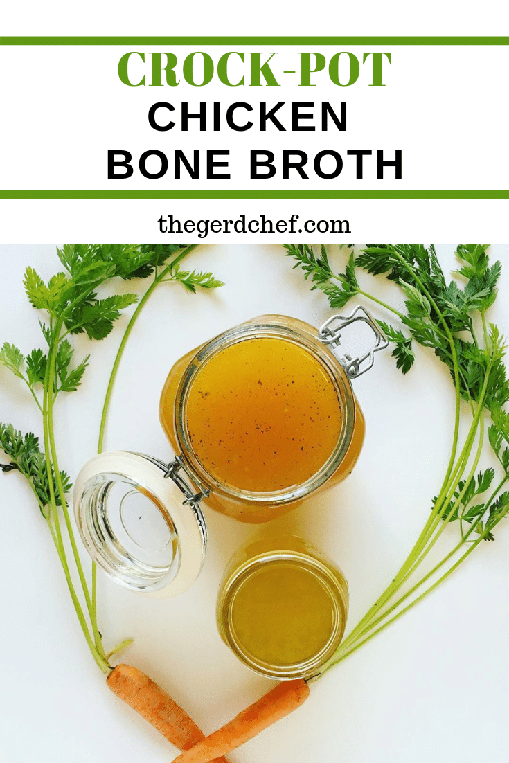 2 jars of homemade crock-pot chicken bone broth, surrounded by fresh carrots