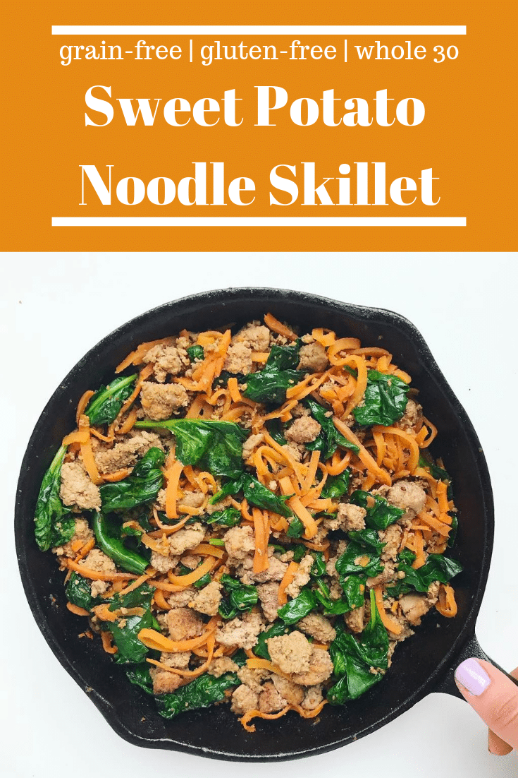 Sweet potato noodles, ground turkey, and wilted spinach in a cast iron skillet