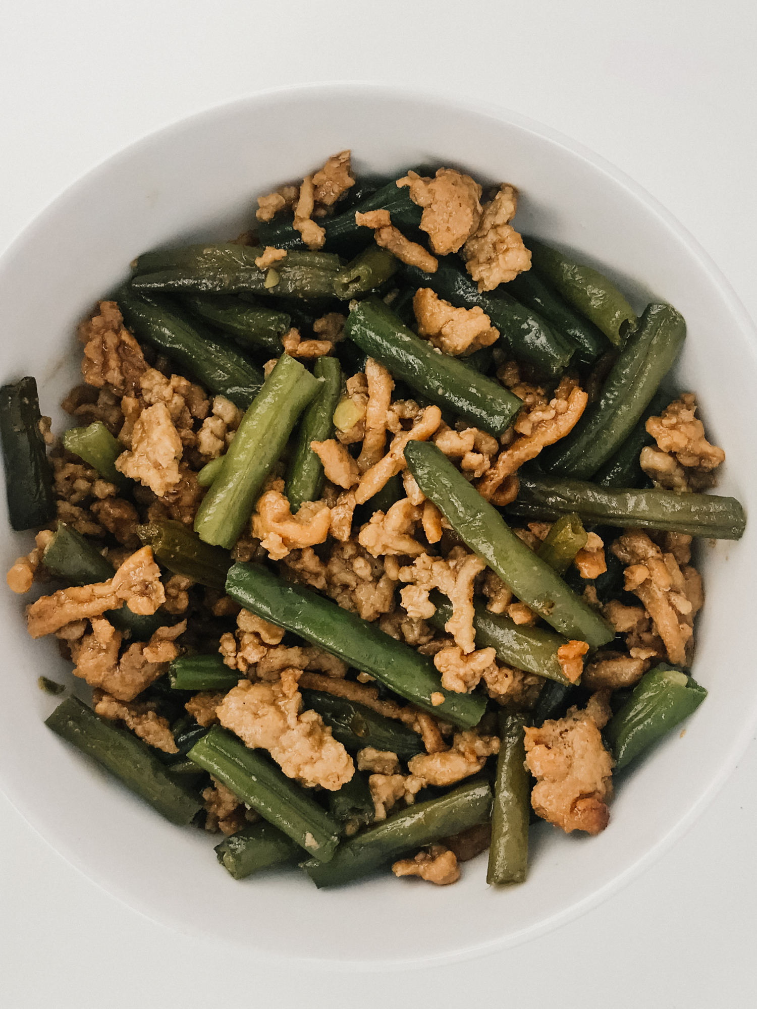 a big white bowl of Asian Chicken and Green Bean Stir Fry