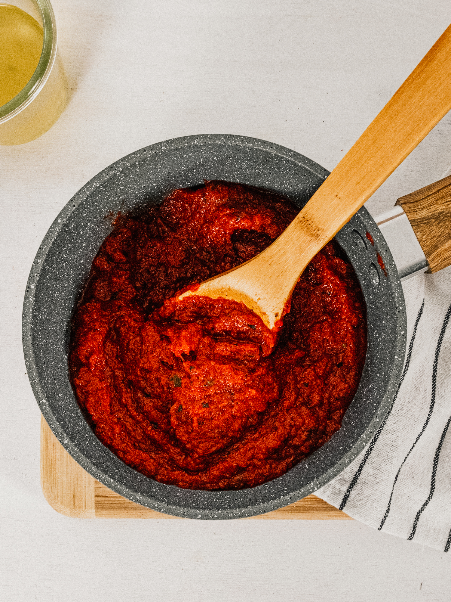 a pot of tomato free pasta sauce with a wooden spoon ready to be heated and served