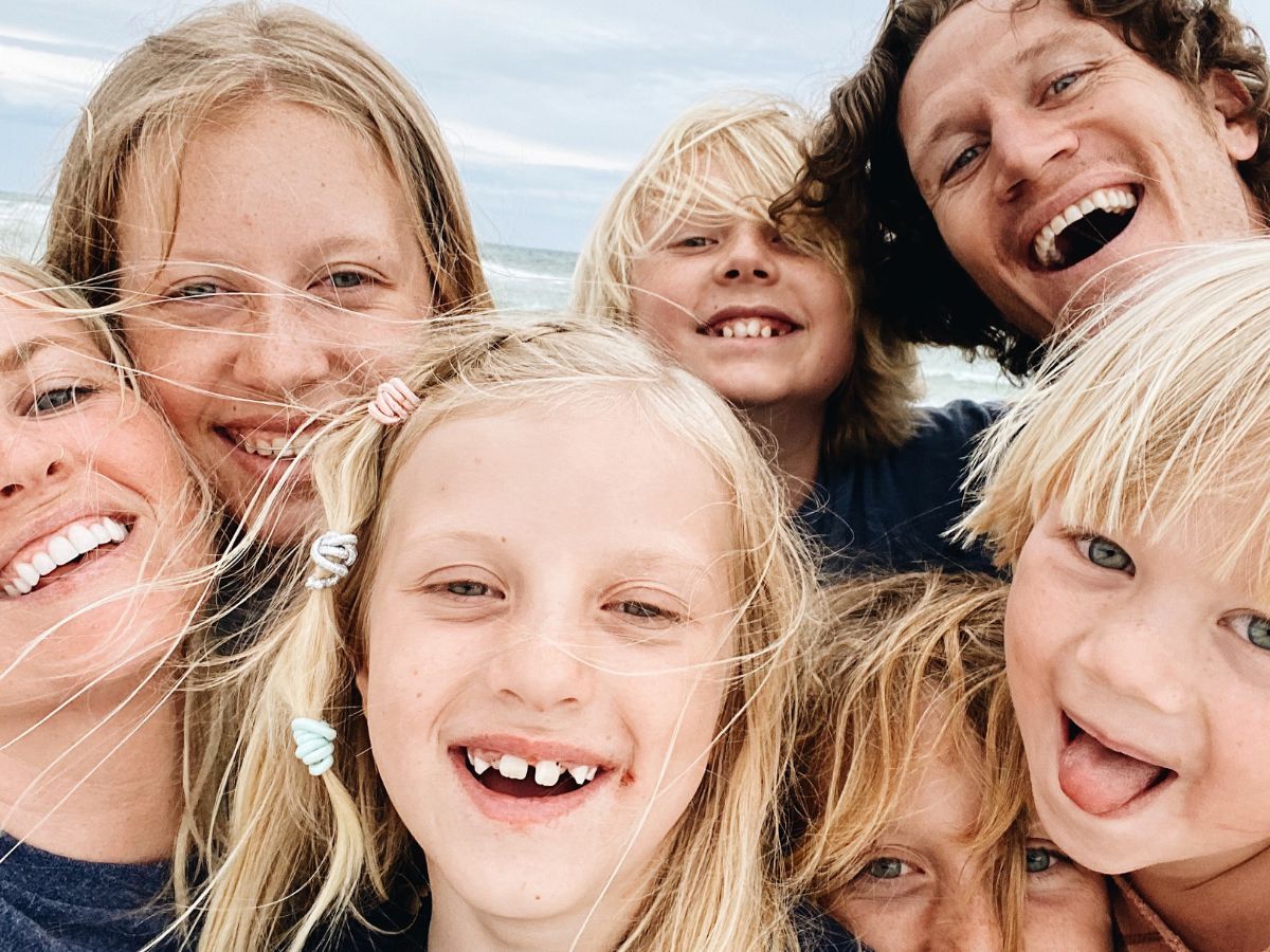 a blond haired family on the beach