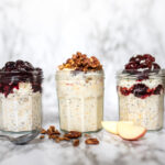 Three jars of coconut milk overnight oats with three different varitaions of toppings and flavors