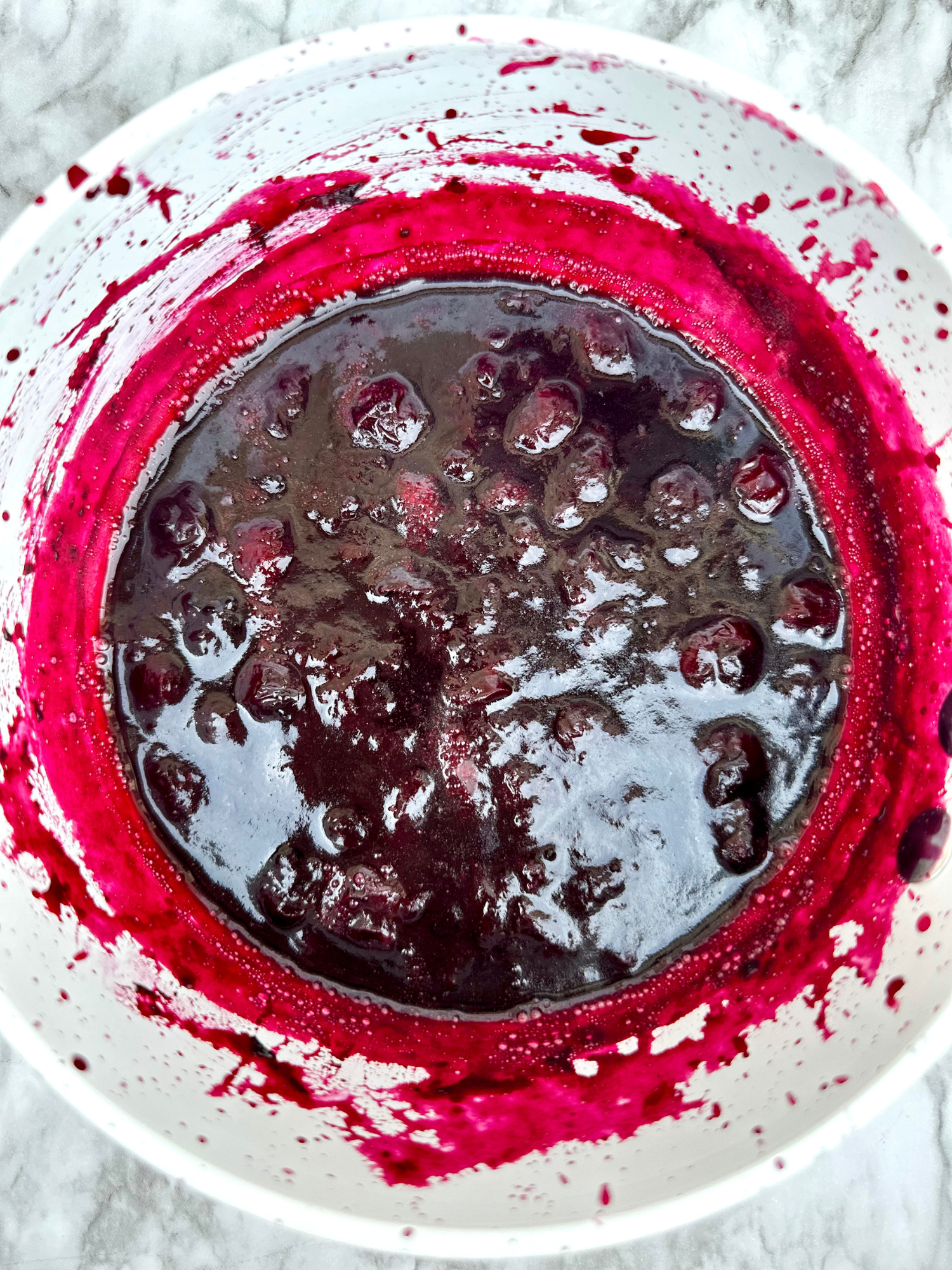 a saucepan of simmering homemade blueberry sauce