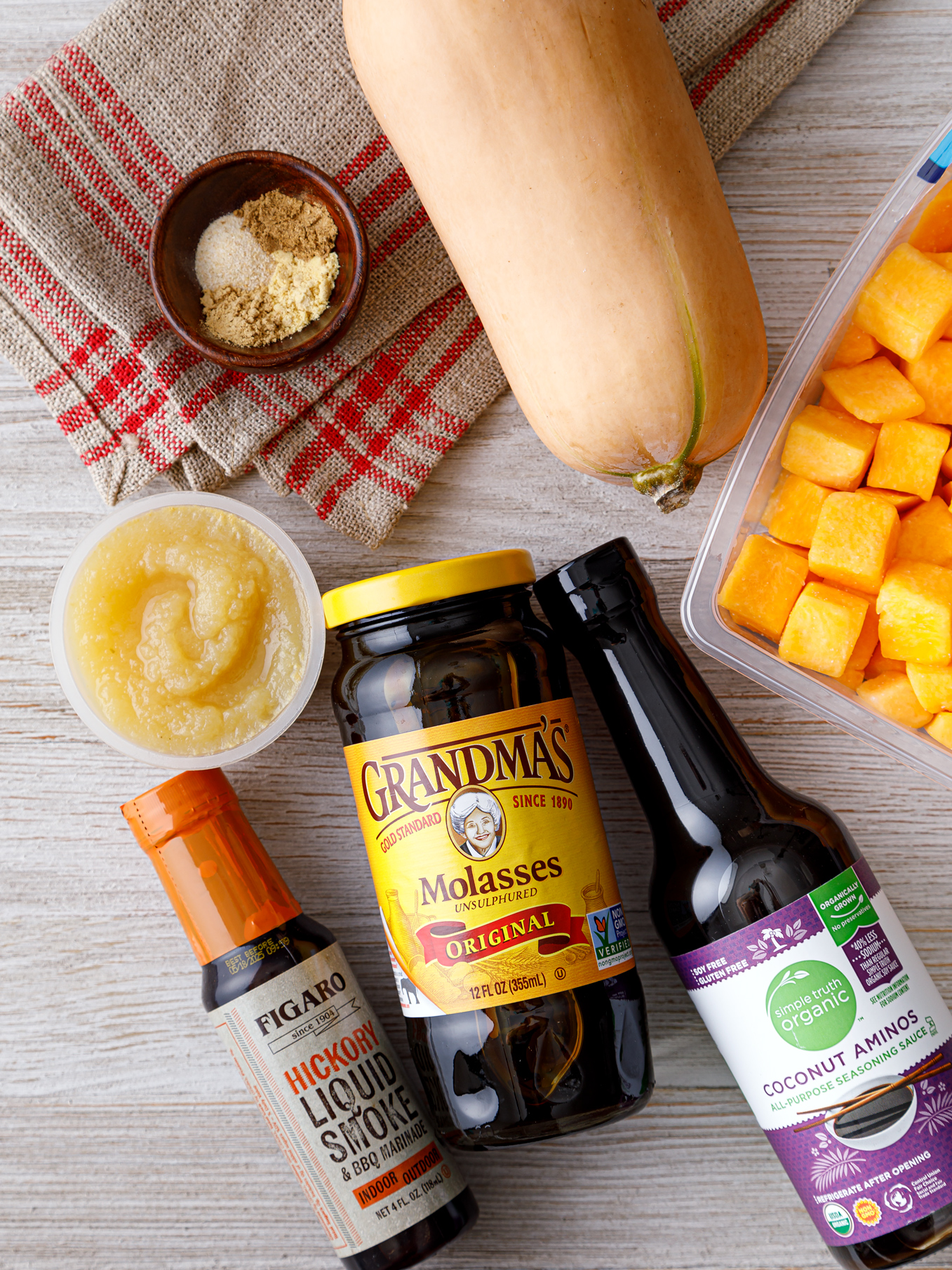 jars of sauce ingredients next to a whole squash