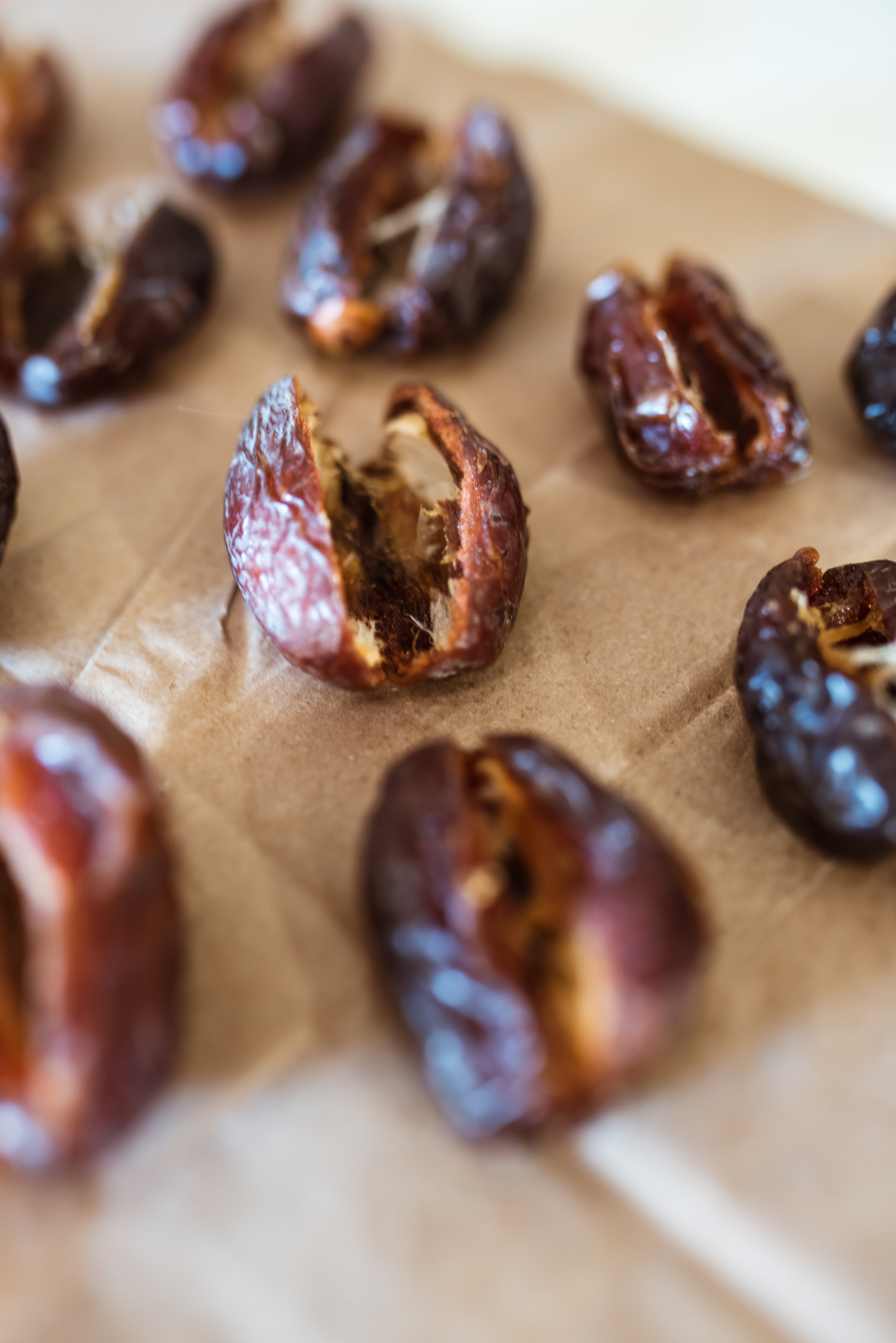 dates lined up on brown paper cut open and ready to be stuffed
