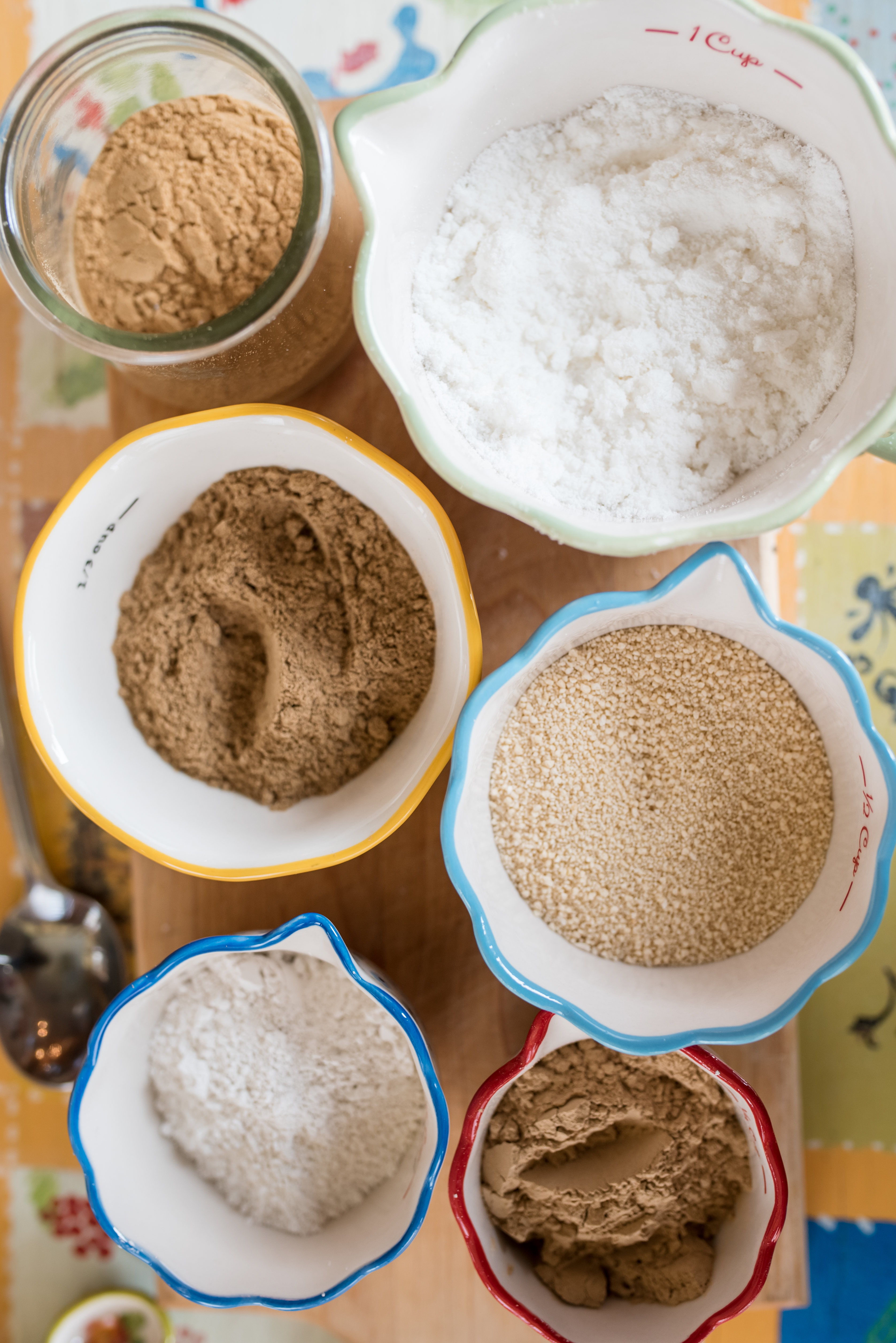 6 small colorful bowls filled with powdered ingredients
