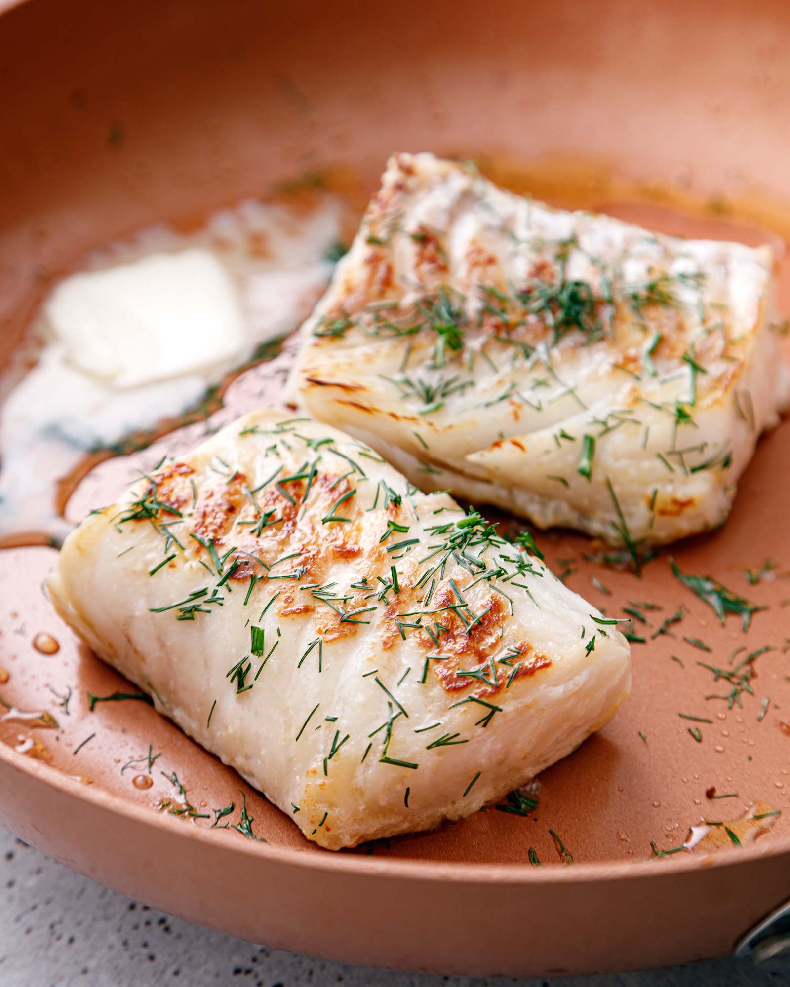 seared sea bass in a skillet