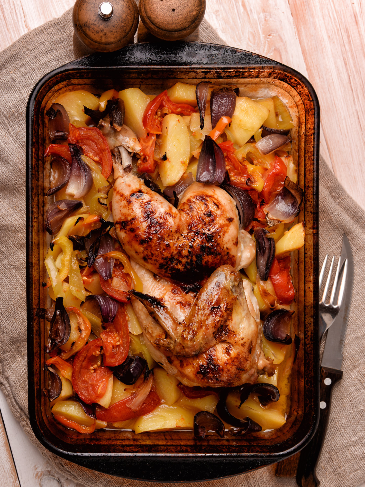 a pan of baked chicken and vegetables