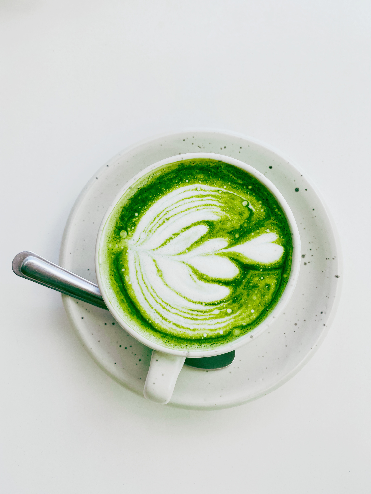 a white cup filled with matcha latte