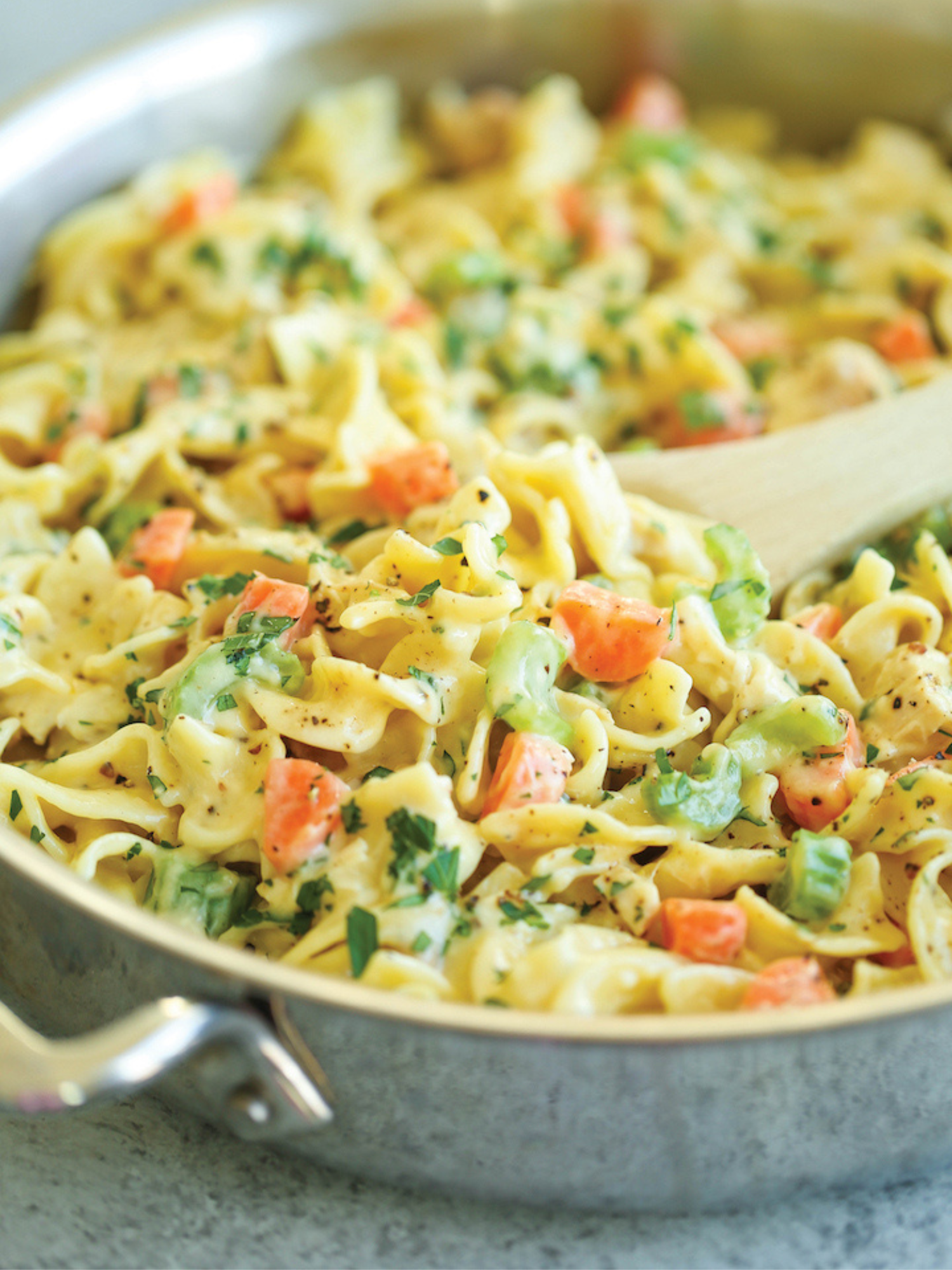 a large stainless steel skillet of creamy chicken noodle pasta