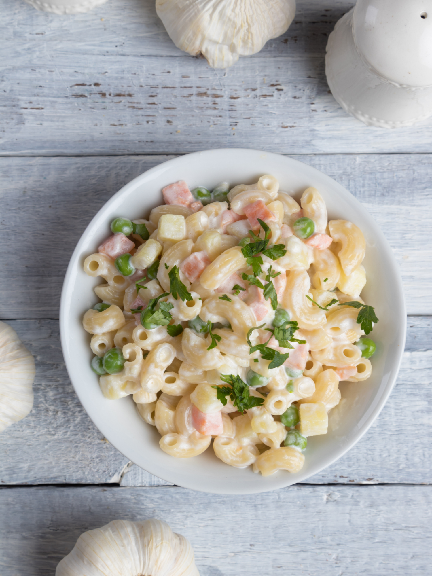 a bowl of heartburn friendly cold macaroni salad on a table