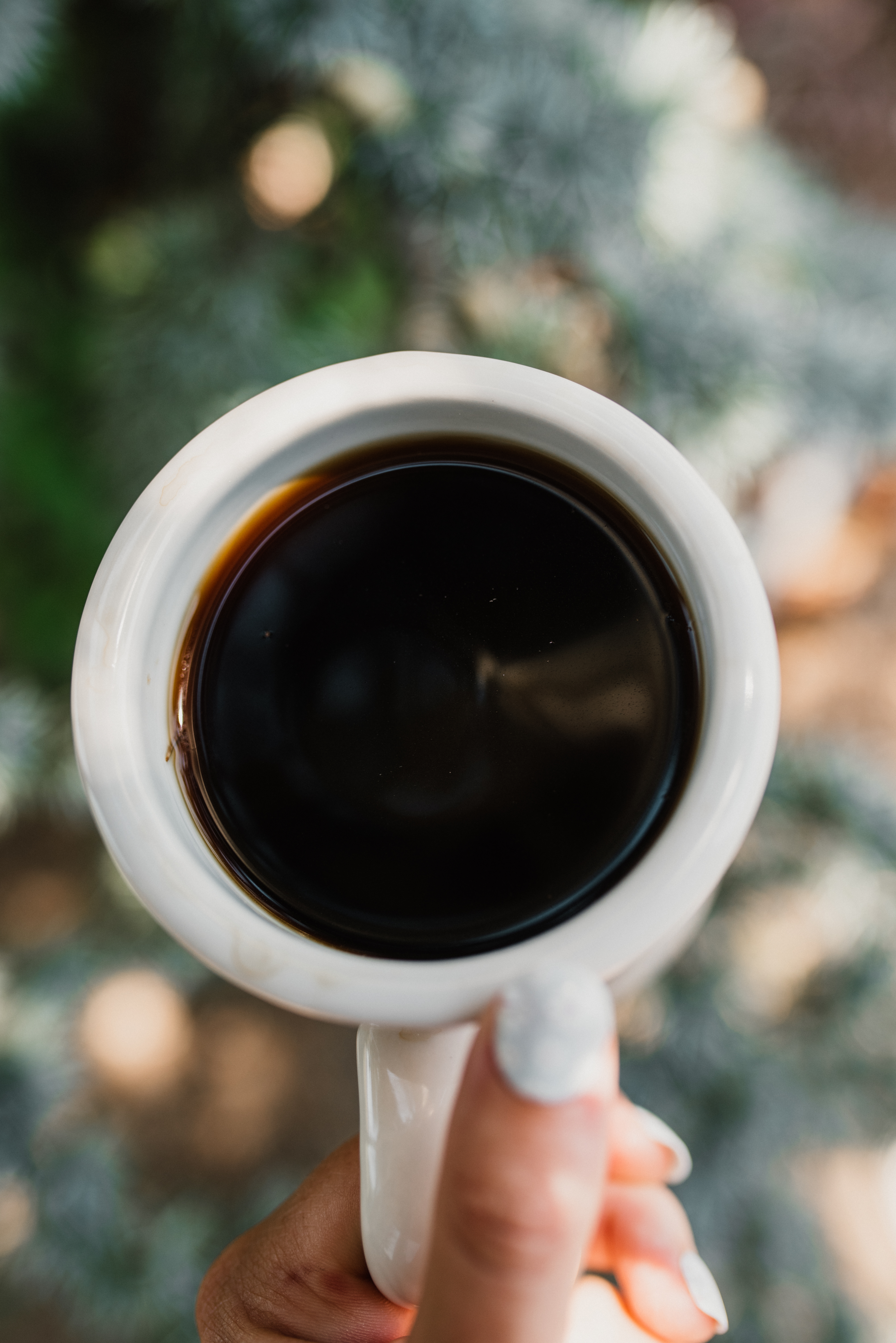 a hand holding a cup of the best coffee for acid reflux