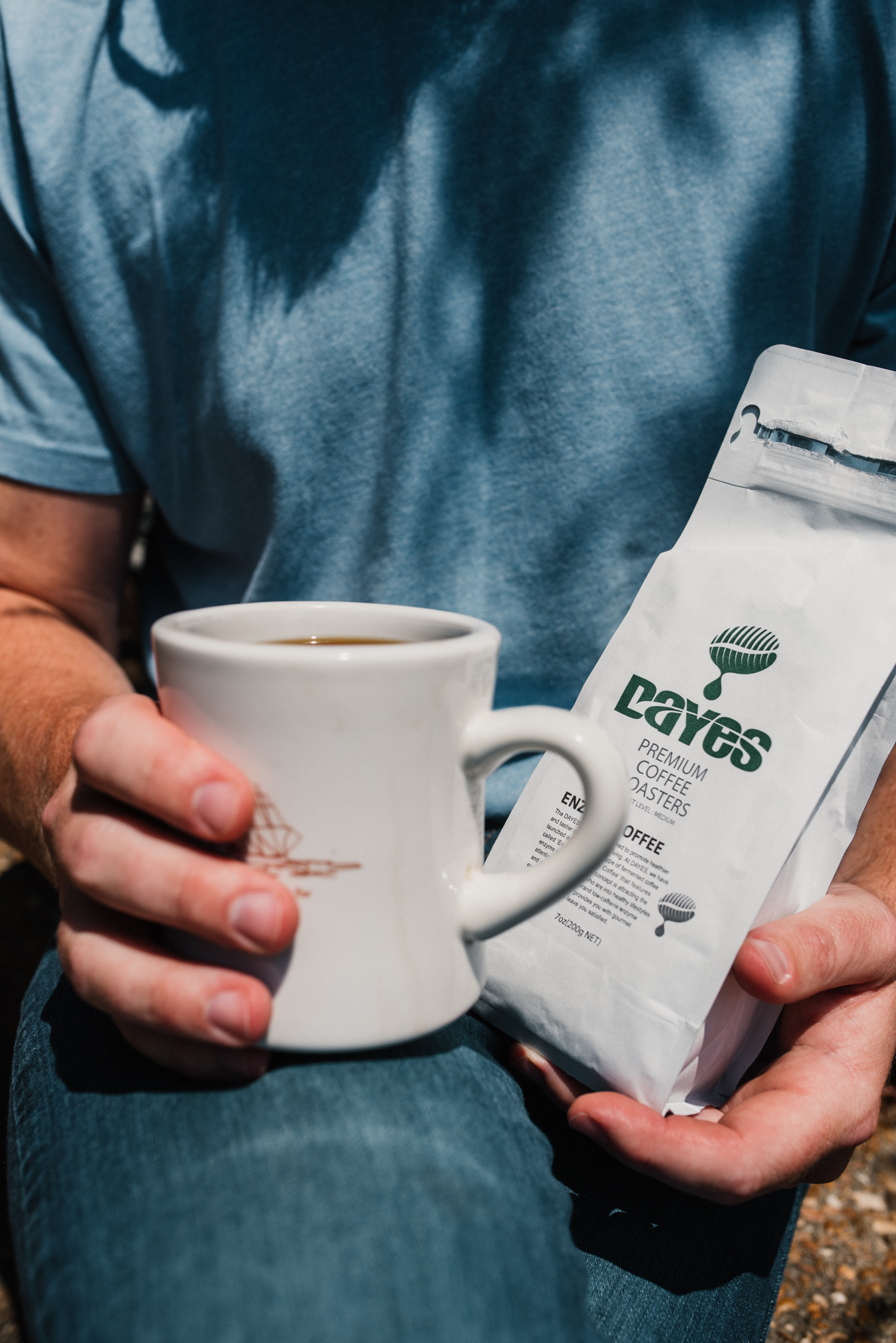 a man holds a cup of the best coffee for acid reflux