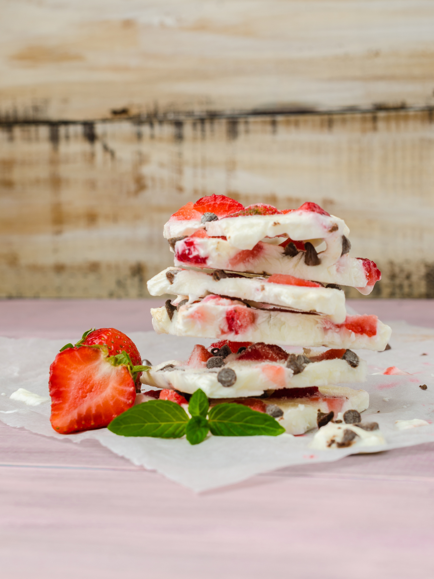 creamy yogurt bark pieces stacked on top of each other