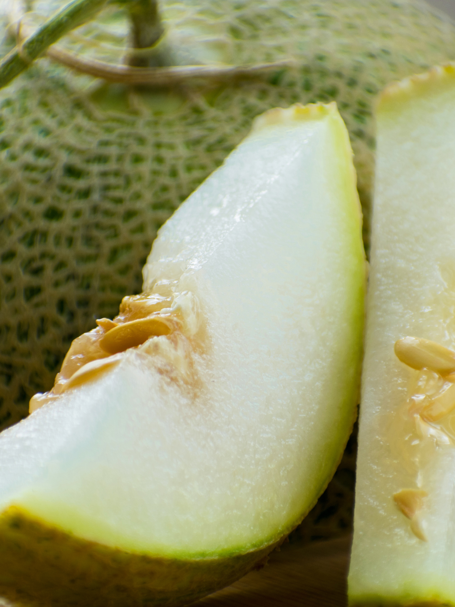 an upclose image of two slices of honeydew melon