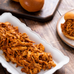 Shredded bbq chicken cooking in a crockpot