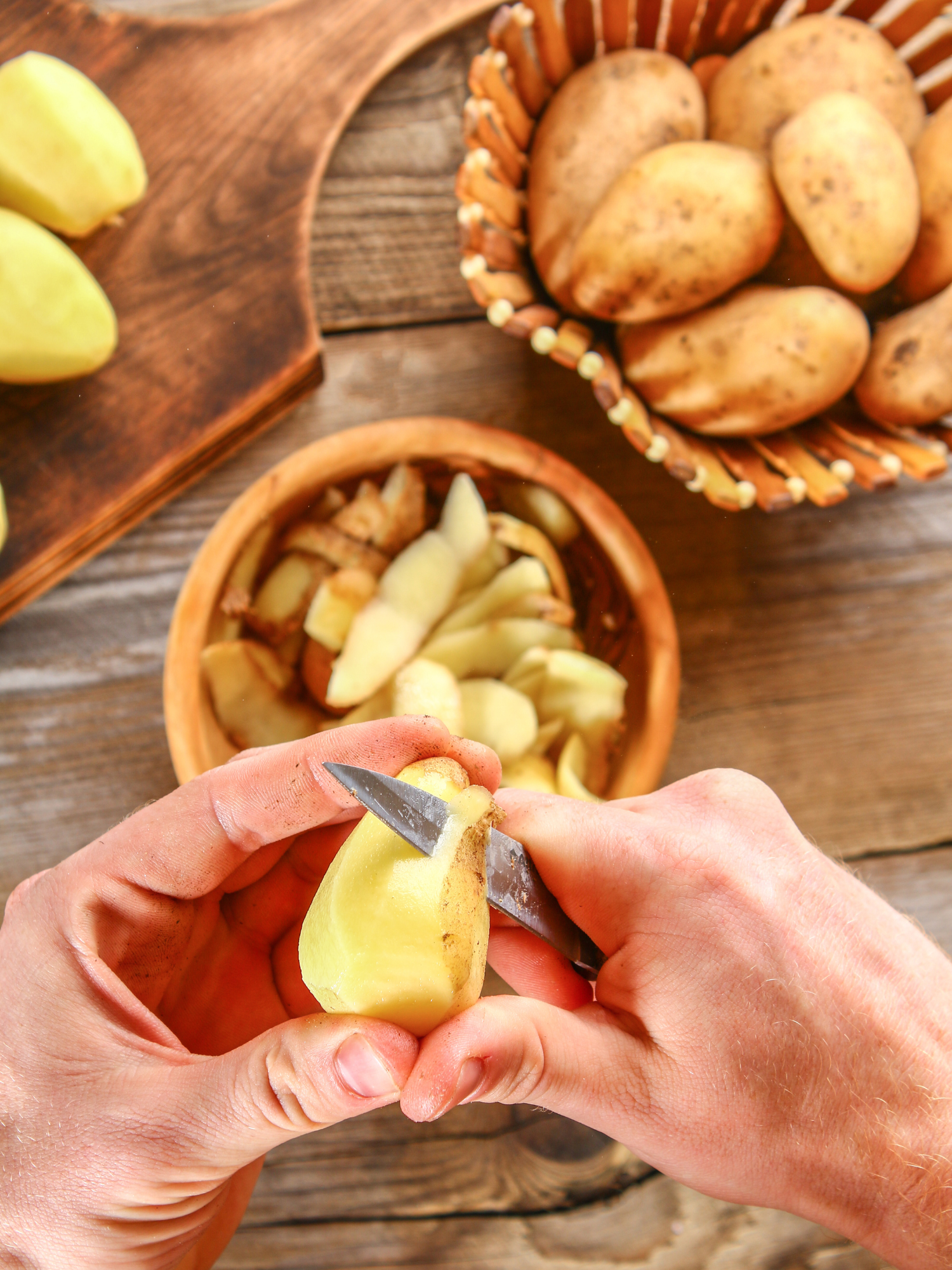 a pair of hands peeling a potato for the Turkish Potatoes