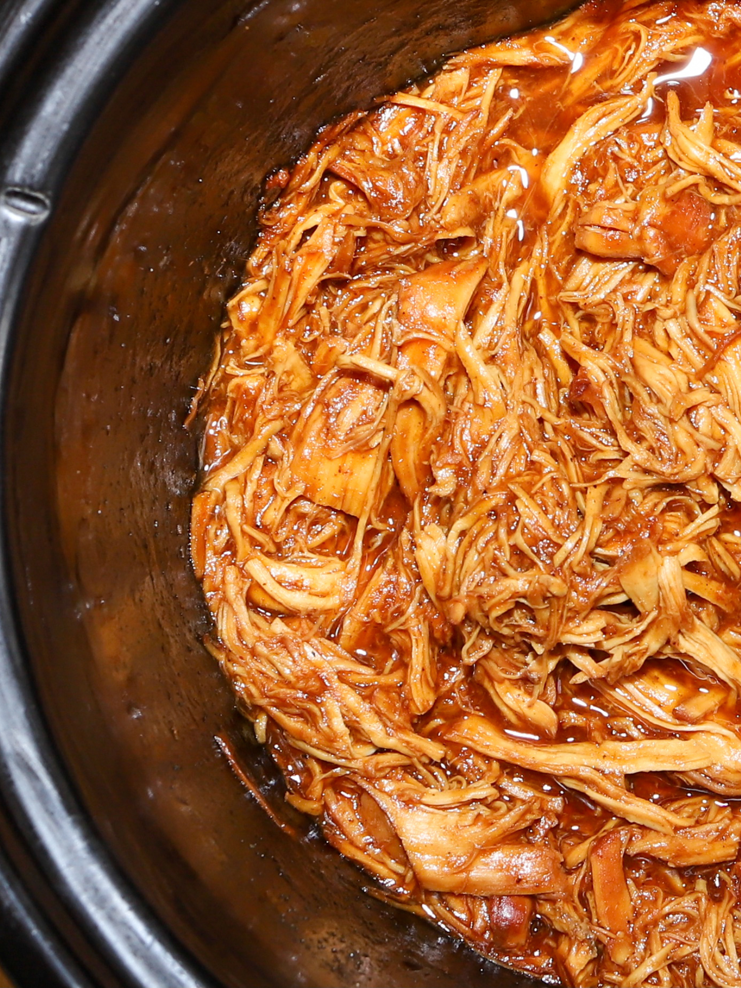 a slow cooker filled with tomato free low acid bbq chicken 