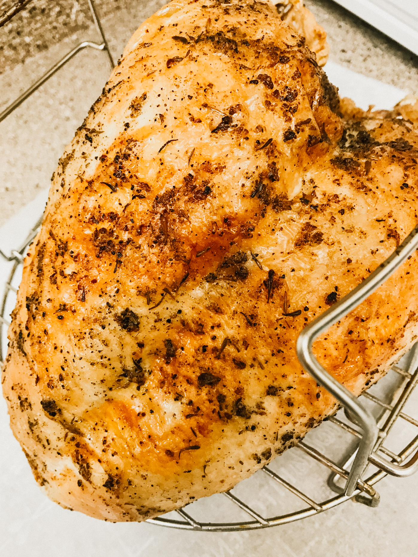 a large herbed turkey breast sitting on the pressure cooker rack